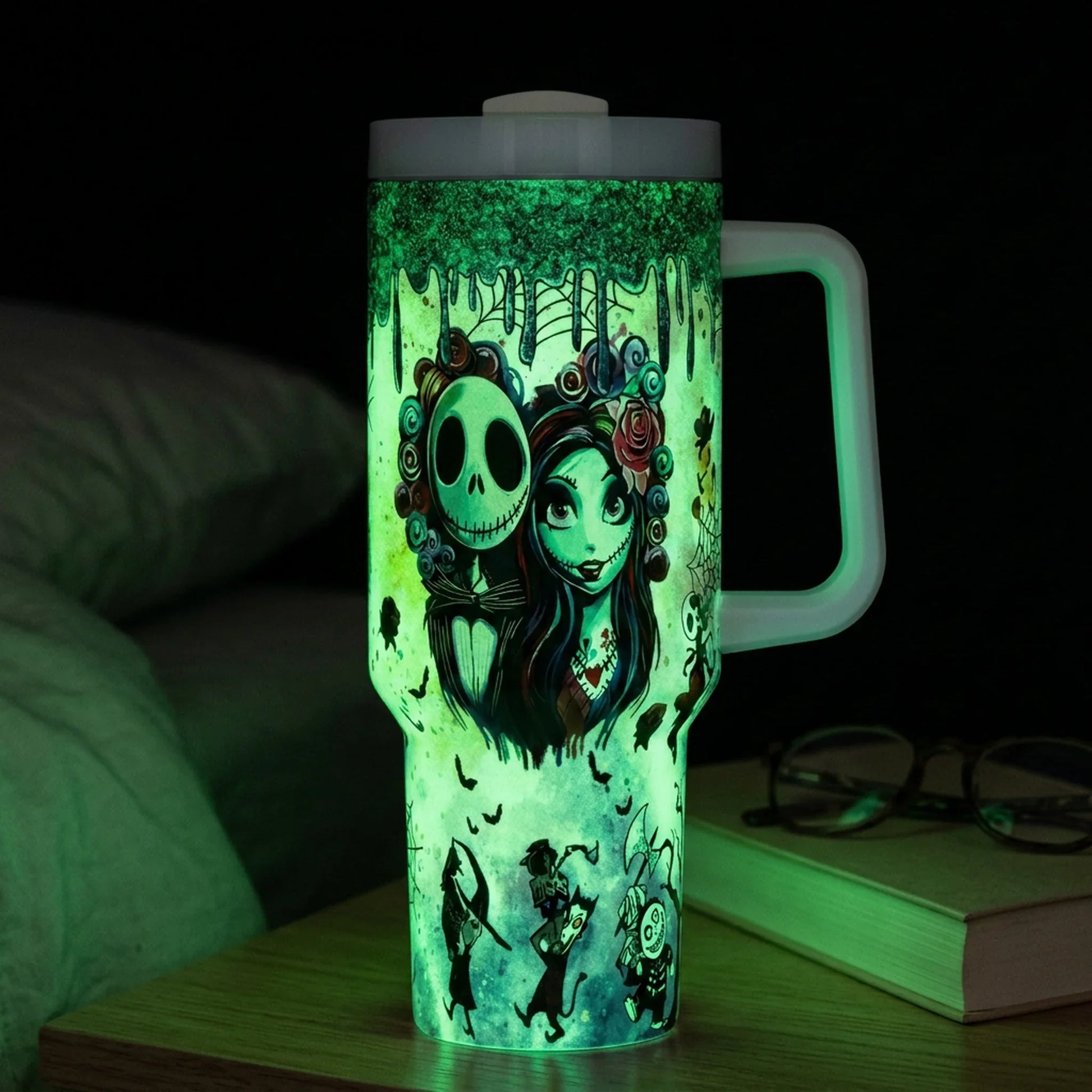 Glow Skeleton Couple 40 Oz Tumbler glowing on a nightstand